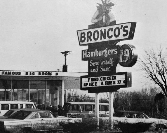 Black and white photo of the original Bronco's sign: Hamburgers, Serv'urself and Save, 19 cents