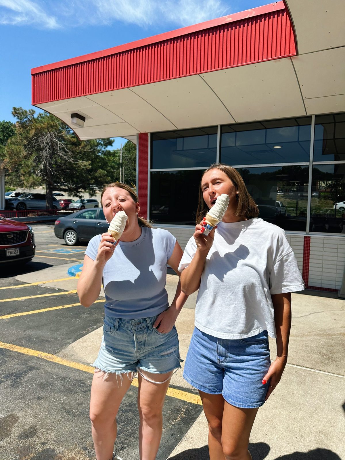 Two customers with ice cream cones outside Bronco's West at 120th and Pacific